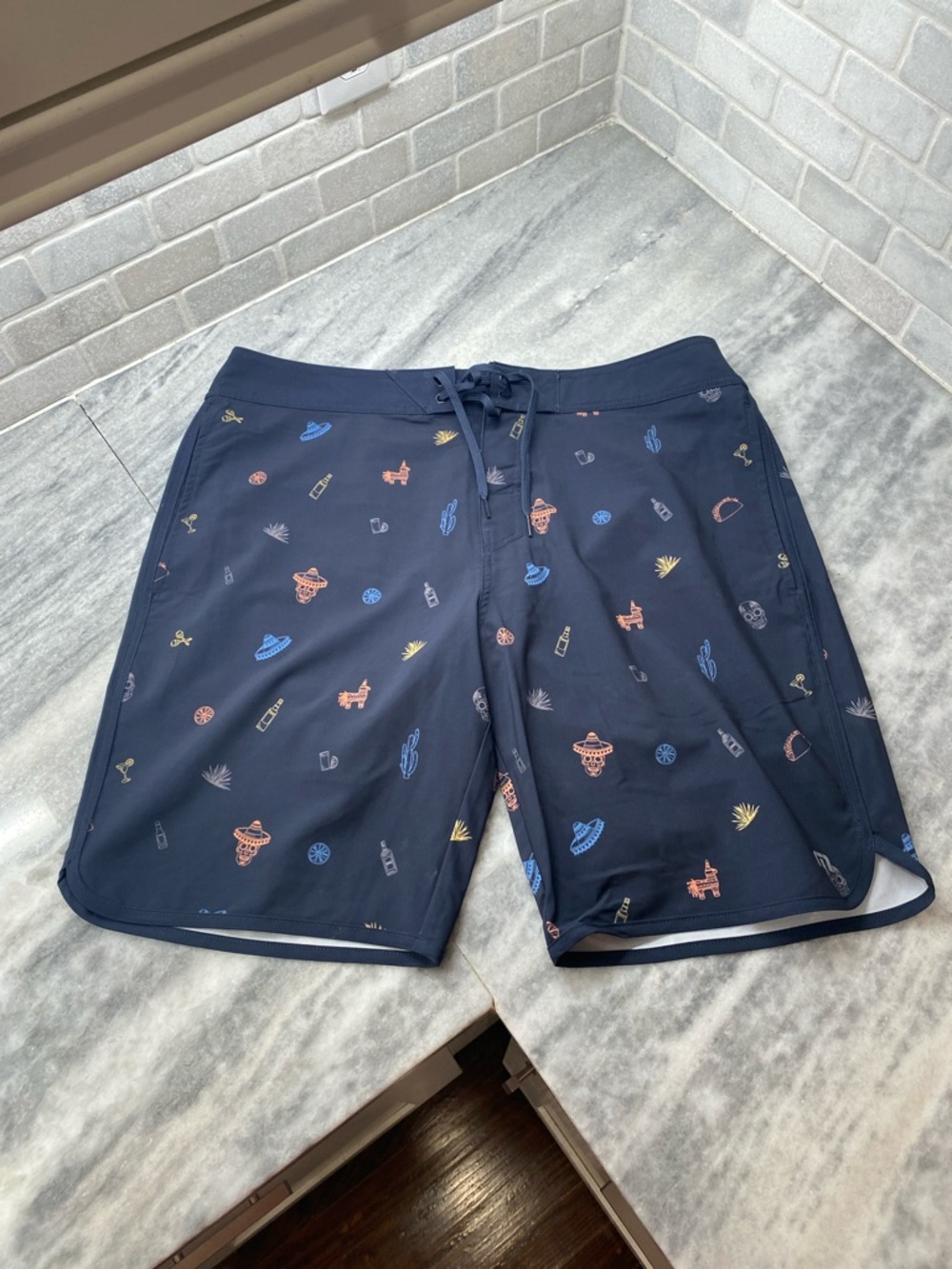 Travis Mathew Navy Swim Shorts with Multicolor Mini Icons